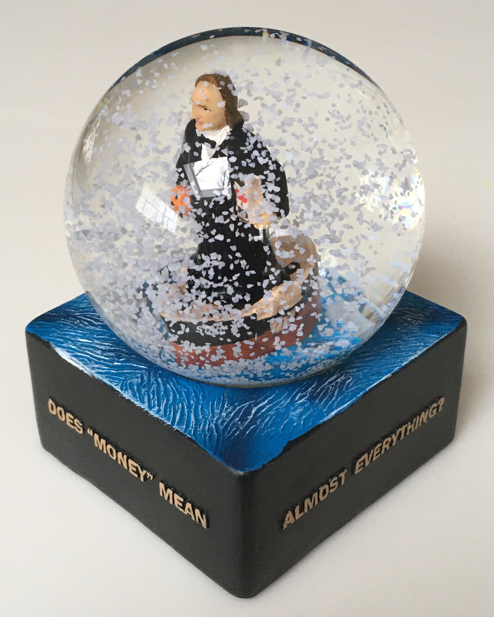 Green Bag snow globe with Justice McLean inside it